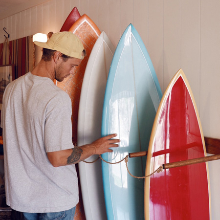 Man standing with surfboards